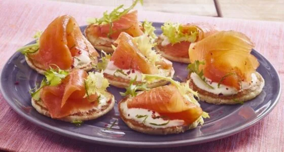 Smoked salmon on blinis with lemon cream sauce appetizer