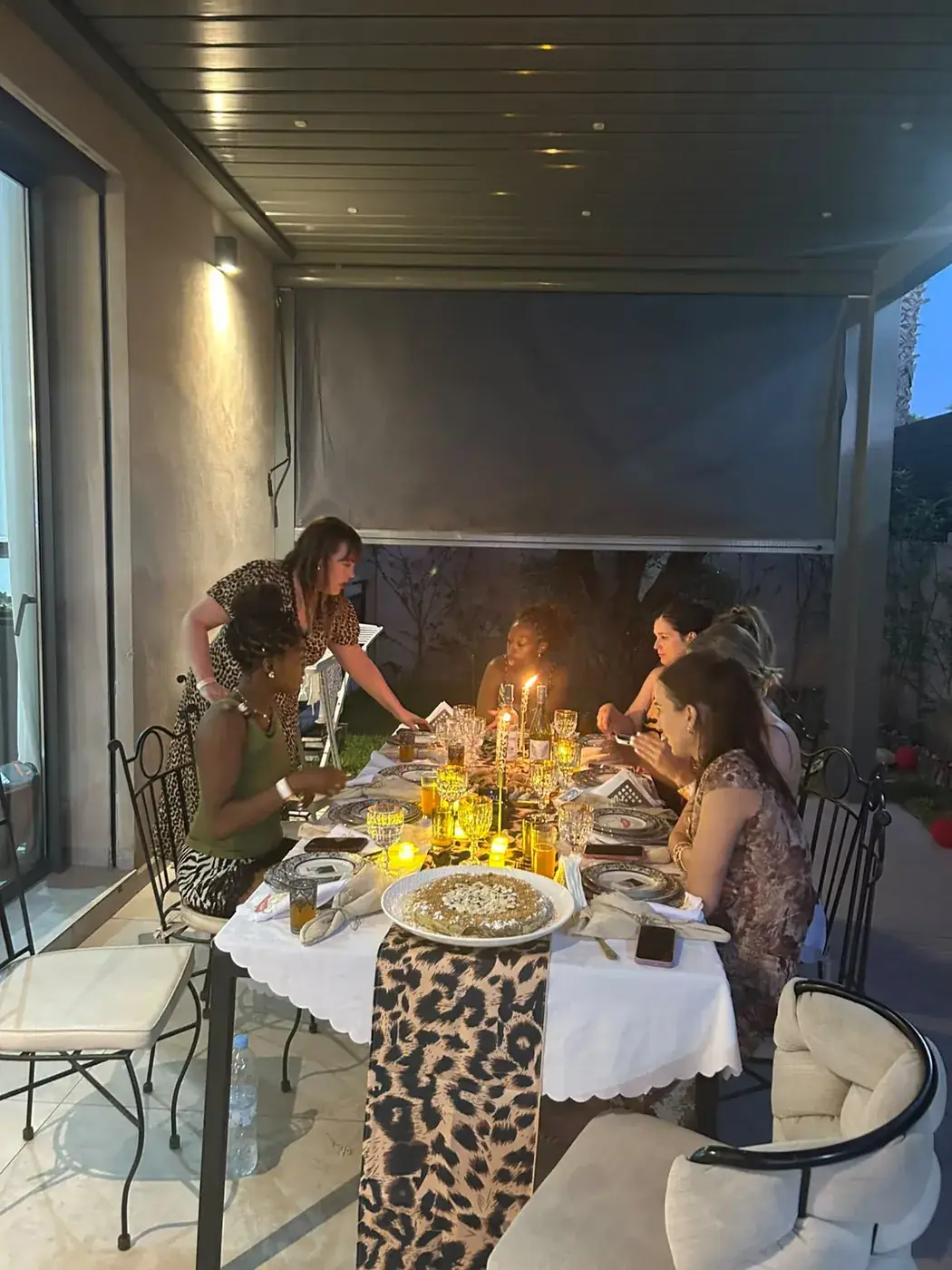 Guests enjoying a candlelit private dinner at a Marrakech villa