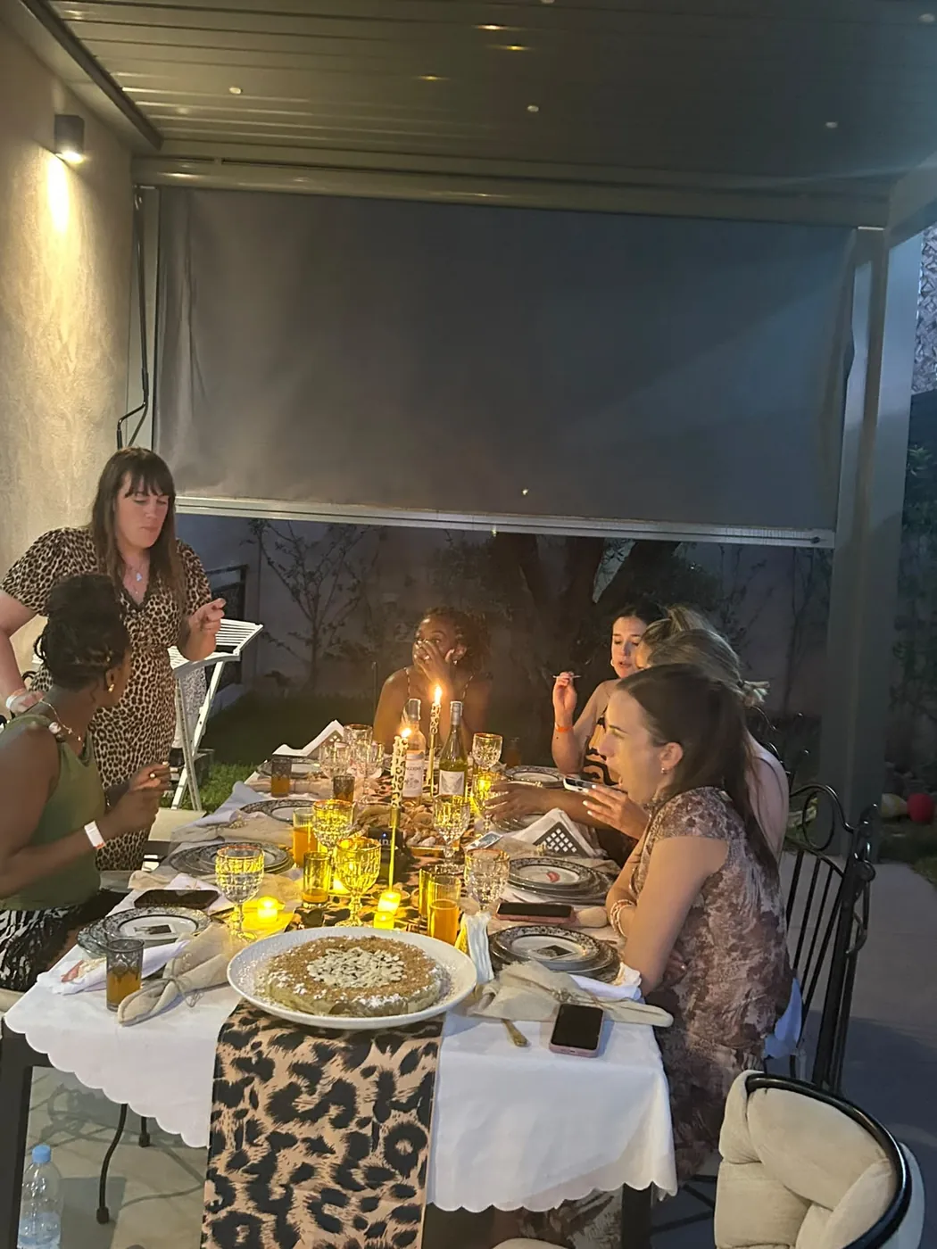 Guests enjoying a warmly lit private dinner table in a Marrakech villa